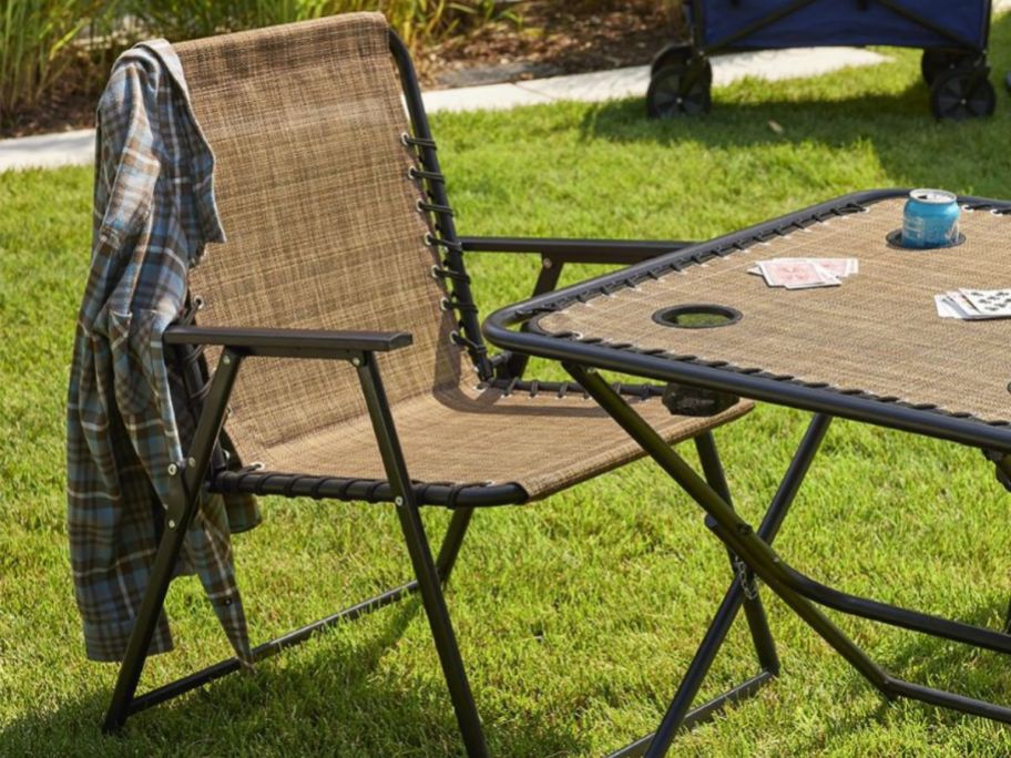 a brown sonoma goods antigravity folding chair and table in brown outside on a lawn