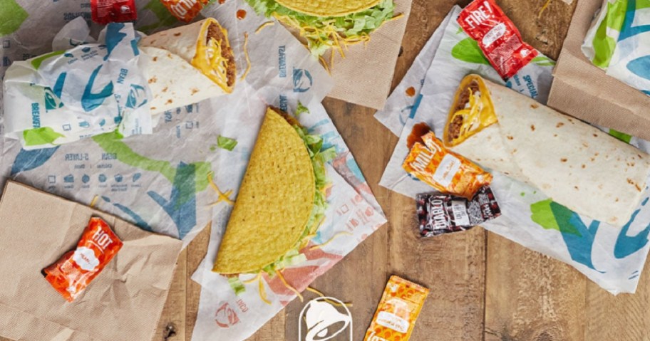 TAco bell food on table top with wrappers and sauce packets