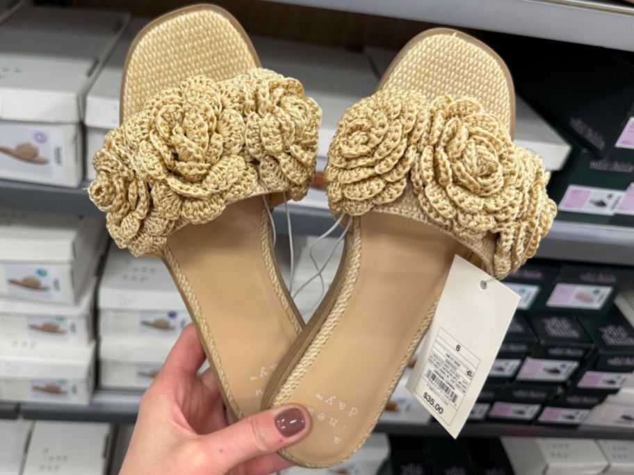 Hand holding a pair of A New Day Women's Coco Raffia Flower Slide Sandals 