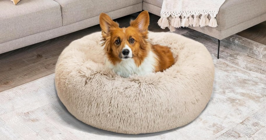 dog inside a taupe faux fur donut pet bed
