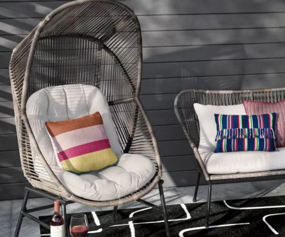 A wicker egg chair on a patio