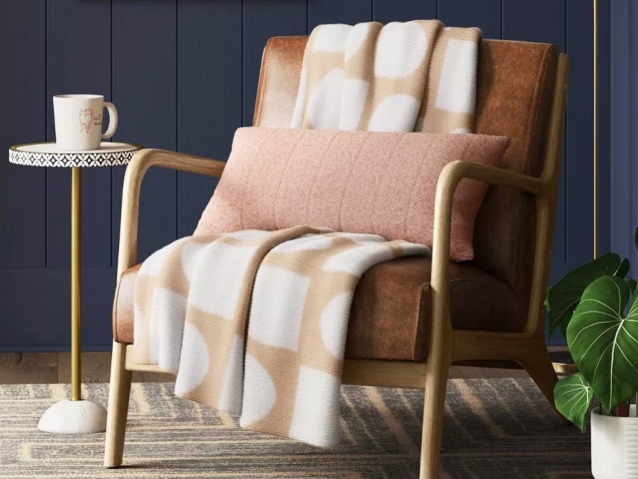 tan and white throw blanket draped over a chair