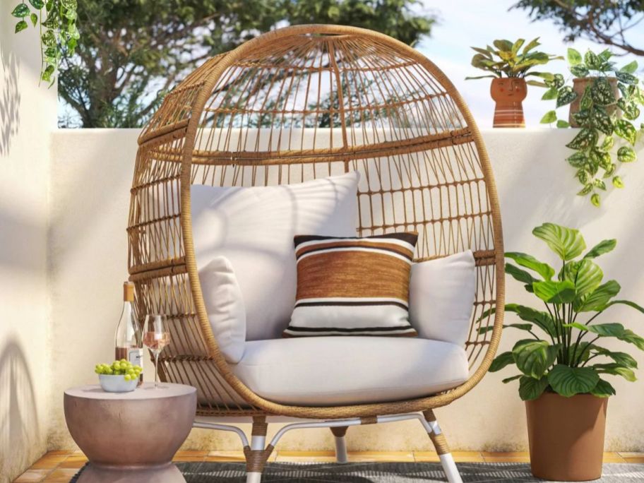 A wicker egg chair on a patio