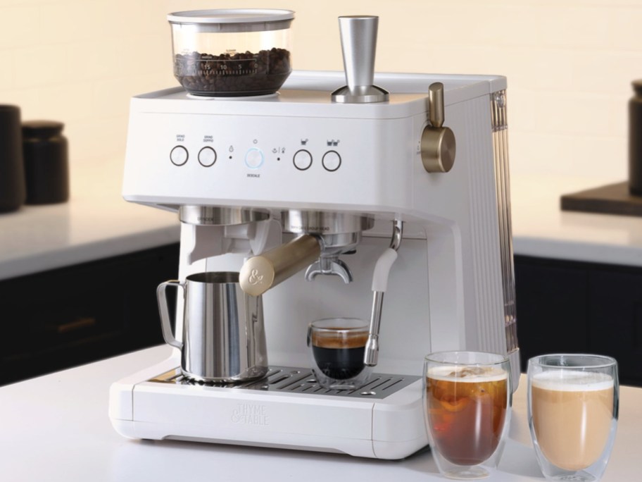 Barista espresso machine with all items shown including coffee grounds, frothier, and two dfferent coffees on the side