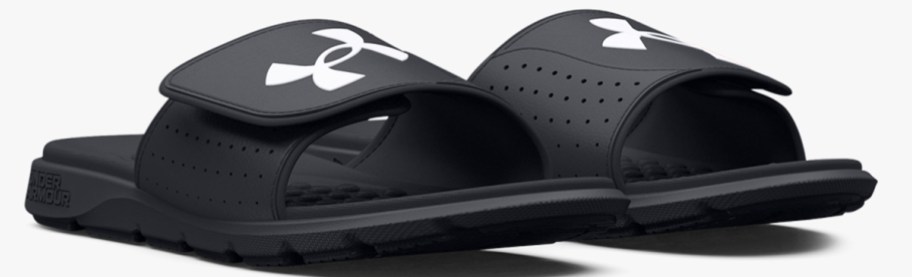 pair of black slides with white under armour logo
