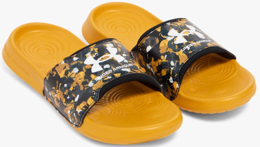 pair of yellow slide sandals with black and yellow straps
