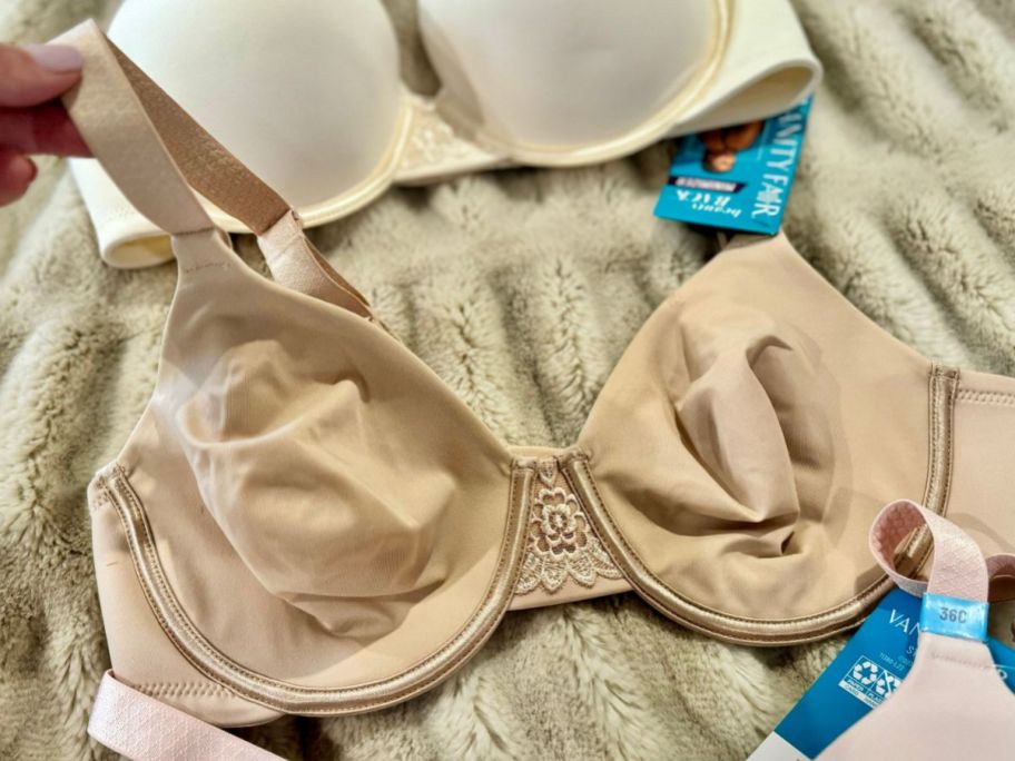 A Vanity Fair Beauty Back Full Figure Underwire Minimizer Bra on a bed