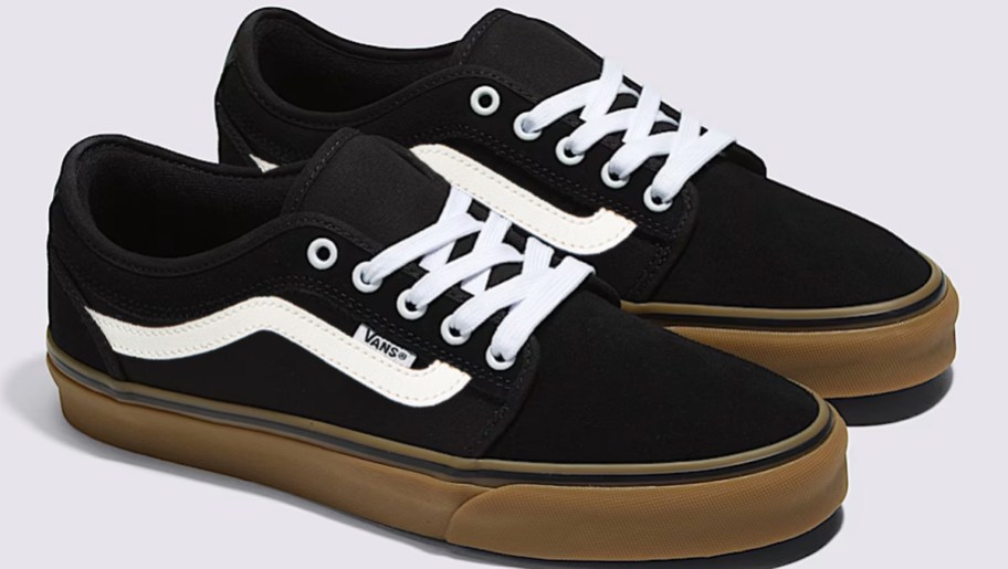 pair of black sneakers with white stripe and brown soles