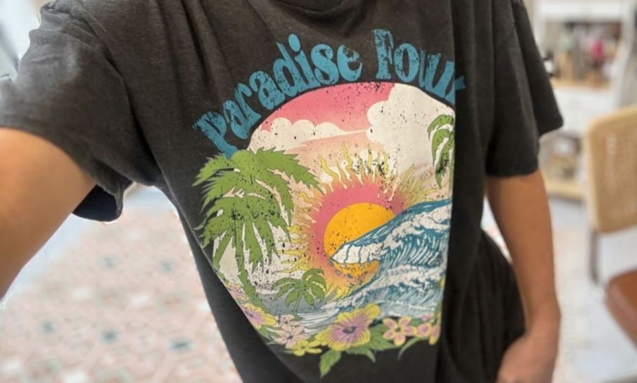a woman in a graphic tee taking a selfie