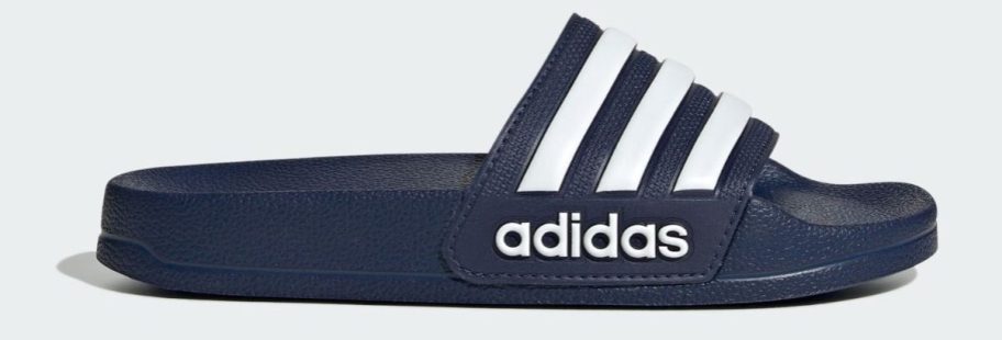 blue and white adidas Kids Adilette Shower Slide stock image