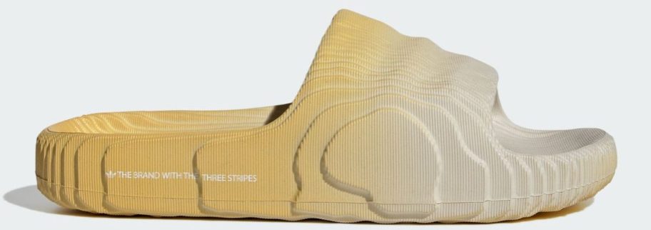 yellow and white adidas Men's Adilette 22 Slide stock image
