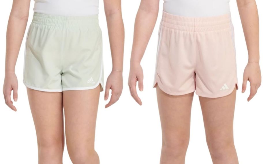 a girl in light green shorts and a girl in light pink shorts