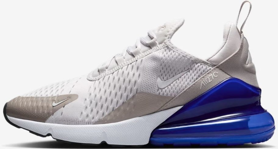 A white, beige and blue mens Nike running shoe