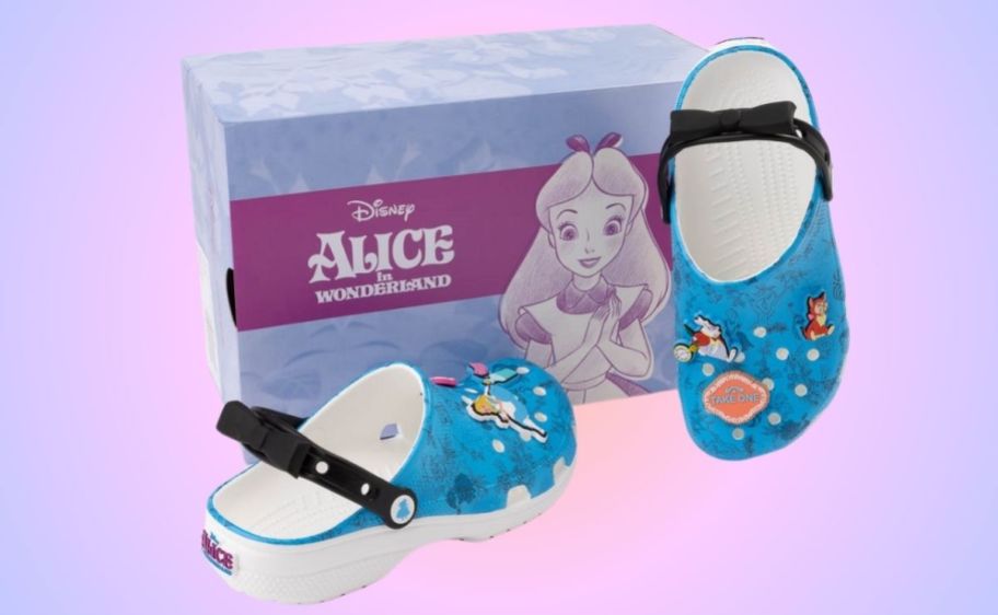 a pair of alice in wonderland themed crocs with jibitz shown with box