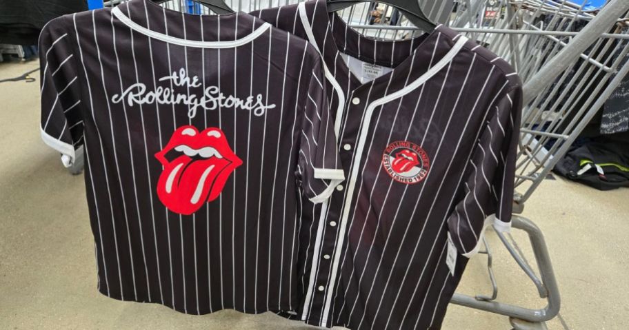 black and white striped Rolling Stones Men's Graphic Baseball Jersey hanging on cart in store