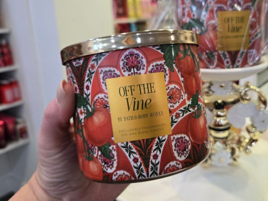 Bath & Body Works Off The Vine 3-Wick Candle in hand in store