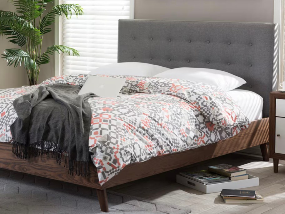 gray bed with floral comforter