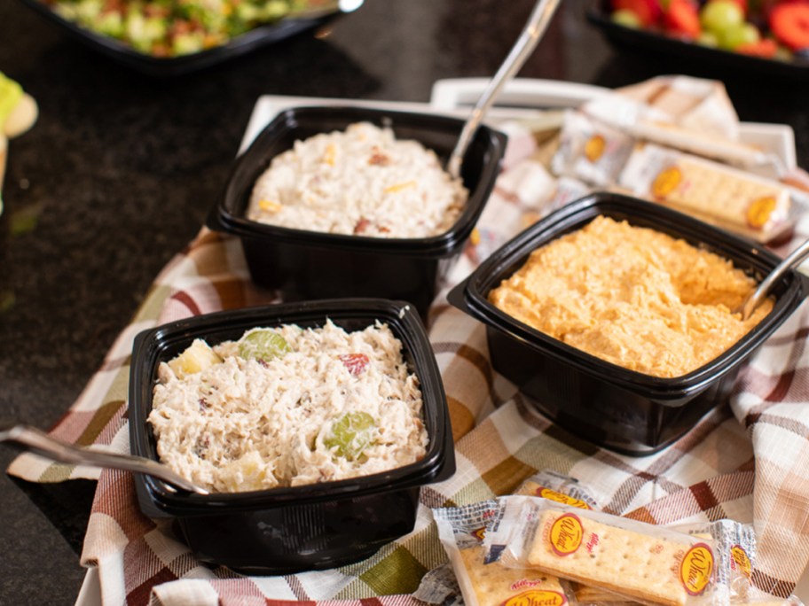 3 chicken salad trays on a table