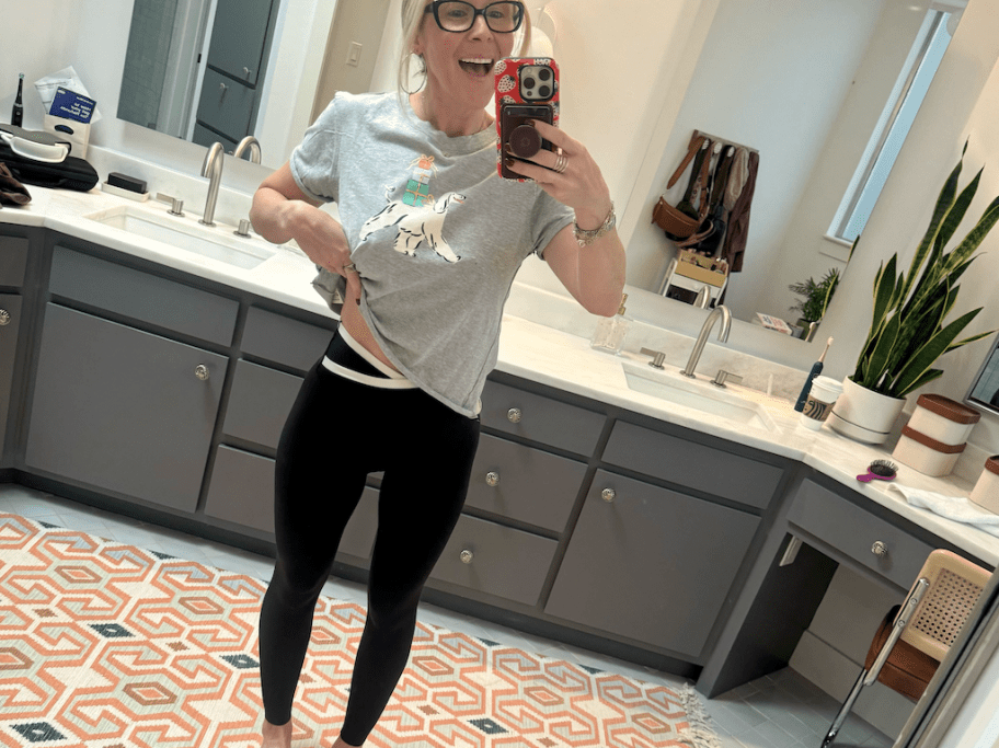 woman wearing gray top and black leggings 