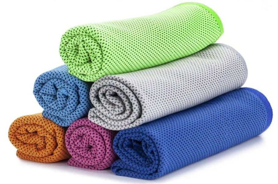 an orange, pink, blue, light blue, grey, and green cooling towel rolled up and stacked on top of each other