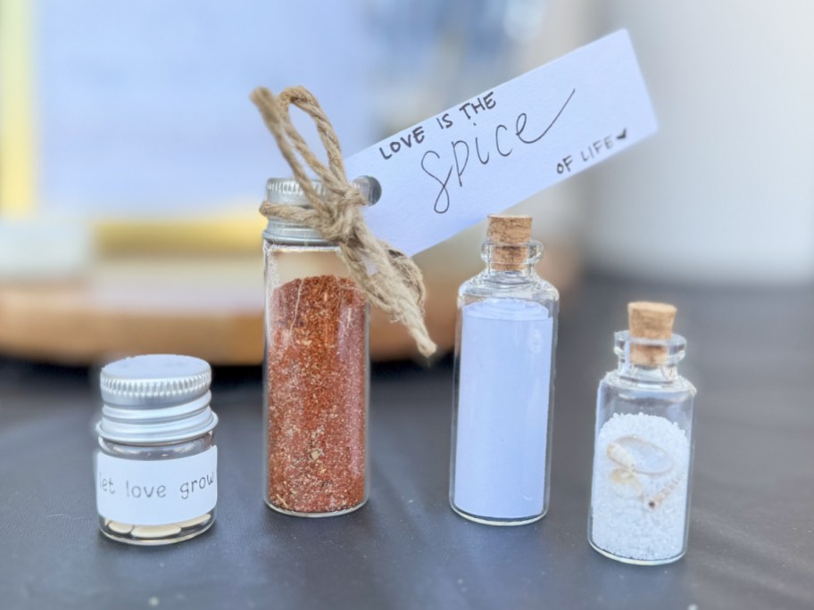 mini glass bottles with spices, sand, and seeds