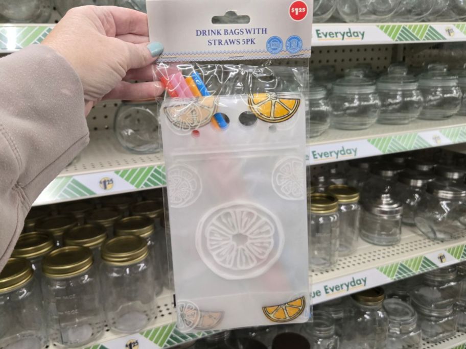 hand holding drink bags with straws package in store