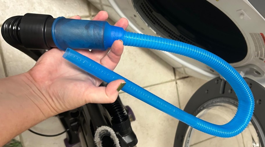 person holding a dryer lint cleaner