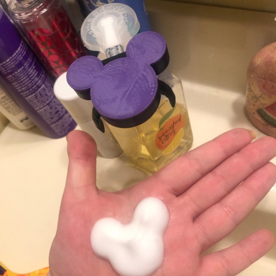 purple mickey head and mickey shaped soap in hand