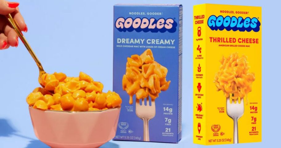 two boxes of goodles mac and cheese next to a bowl filled with mac and cheese
