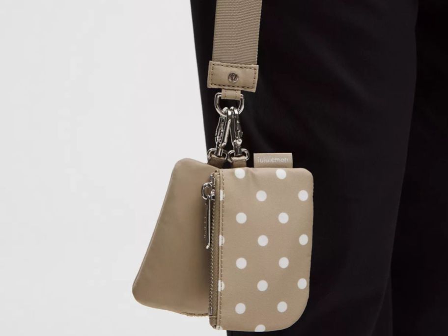 hand holding lululemon Dual Pouch Wristlet