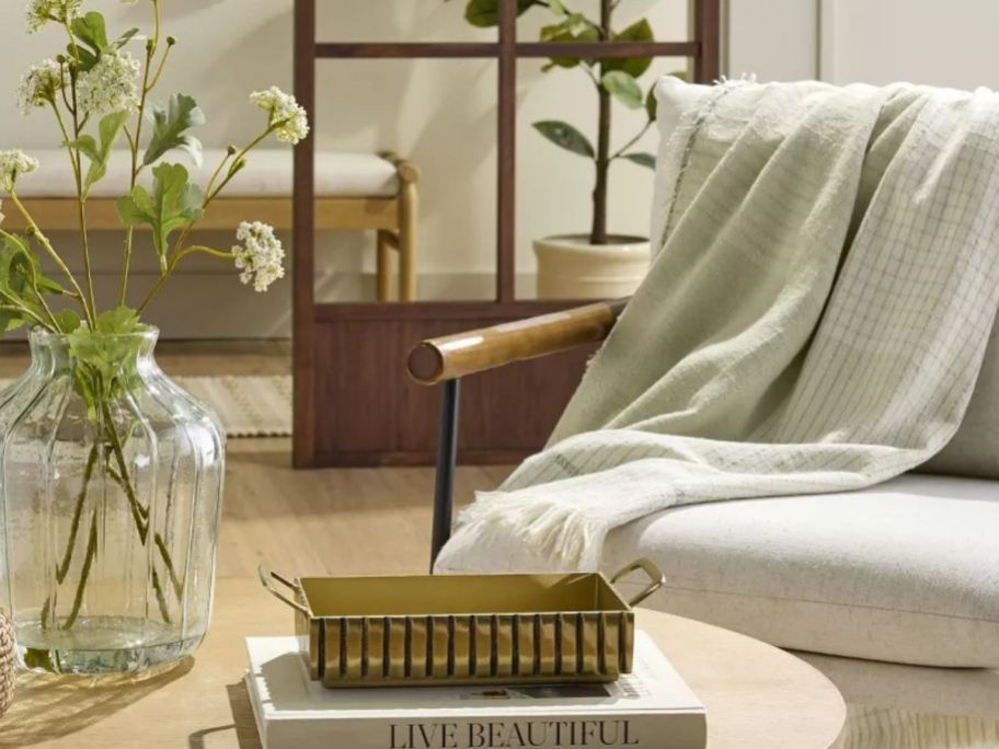 heath and hand woven blanket thrown over chair by table