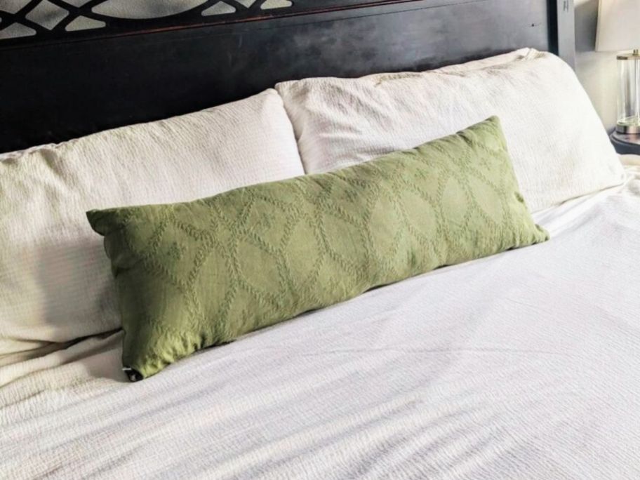 heath and hand green body pillow on bed