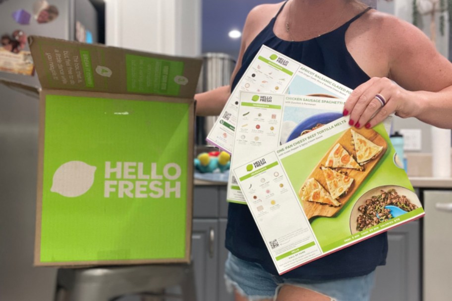 woman holding hello fresh box and recipe cards