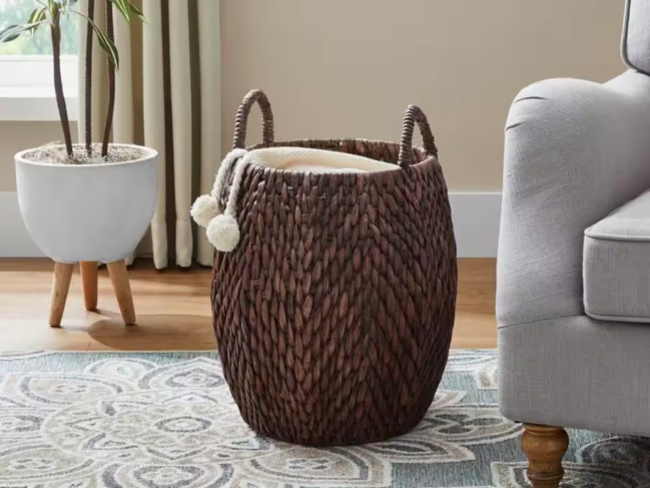 dark brown wicker storage basket with blanket inside 