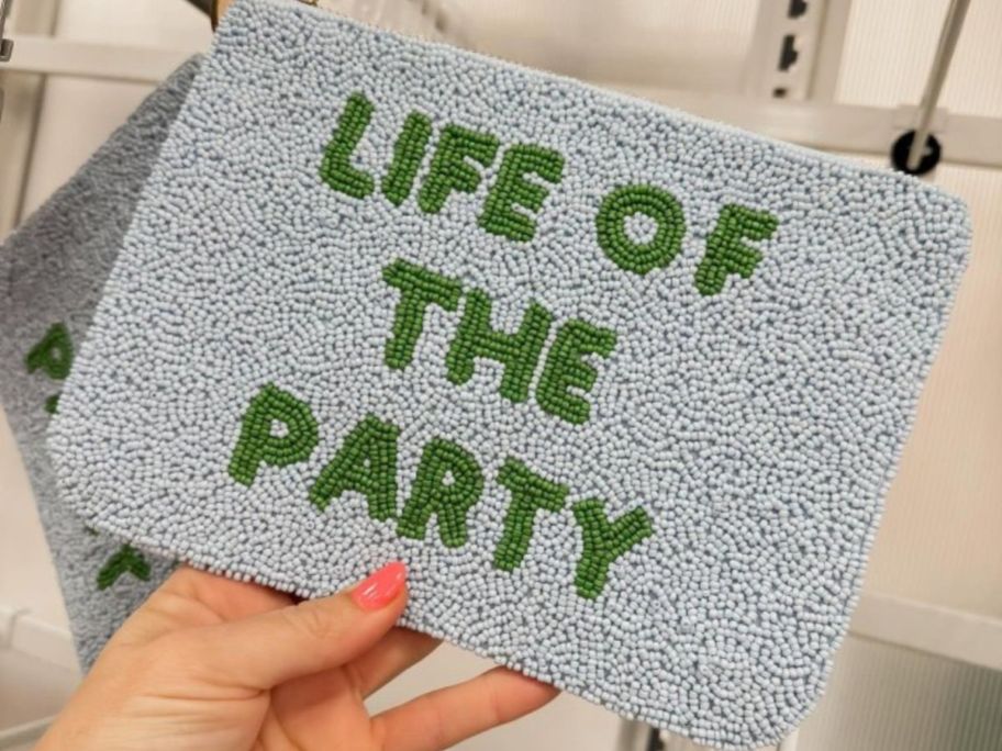 blue and green kate spade new york x Target Life of the Party Beaded Clutch in hand in store