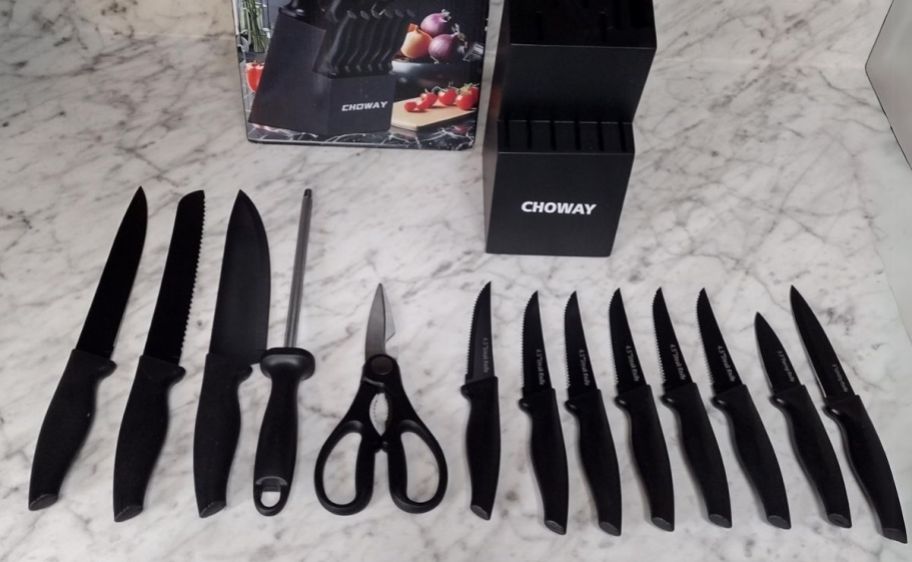 a 14 piece knife set shown with black knife block and packaging. displayed on a countertop
