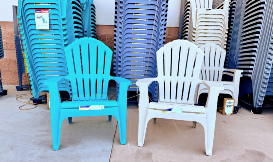 two adirondack chairs next to each other with more stacked behind them