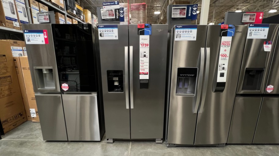 three refrigerators lined up next to each other on display at lowes