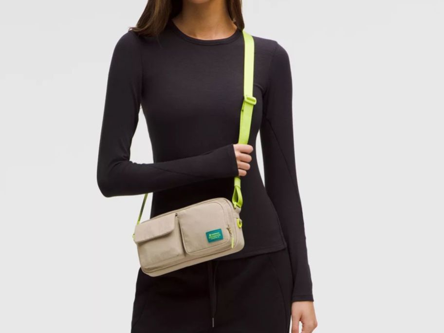 woman wearing yellow and beige lululemon Multi-Pocket Crossbody Bag around her shoulder