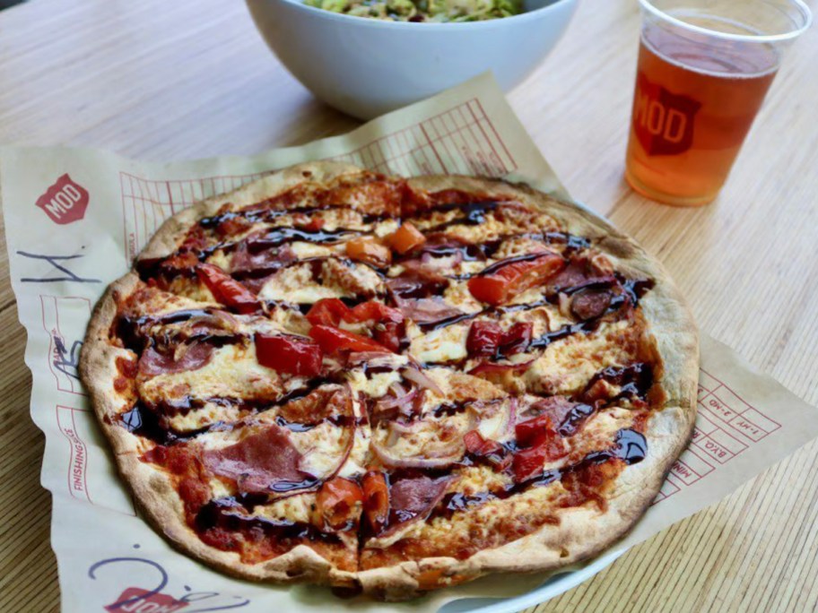 mod pizza on table with drink