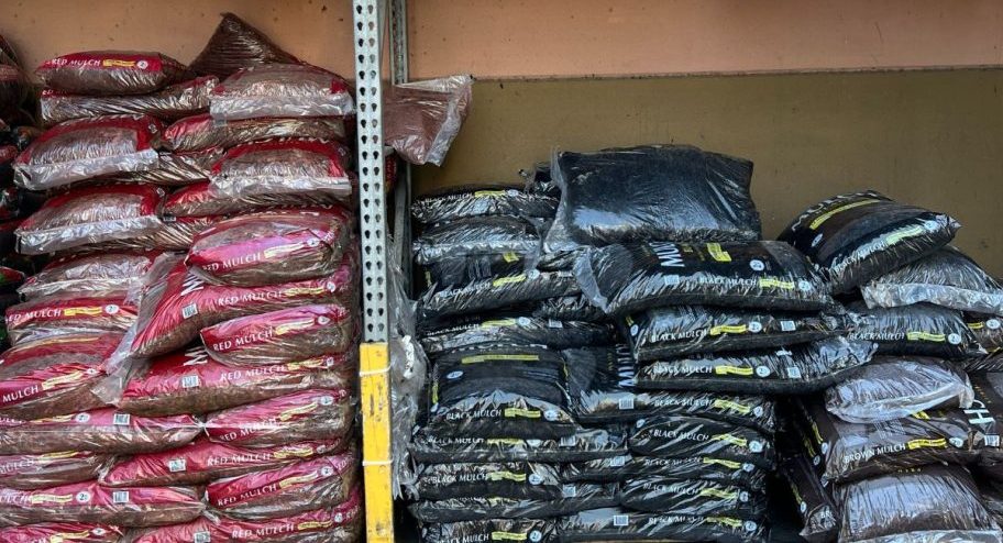 red and brown mulch bags with three for ten sale signs