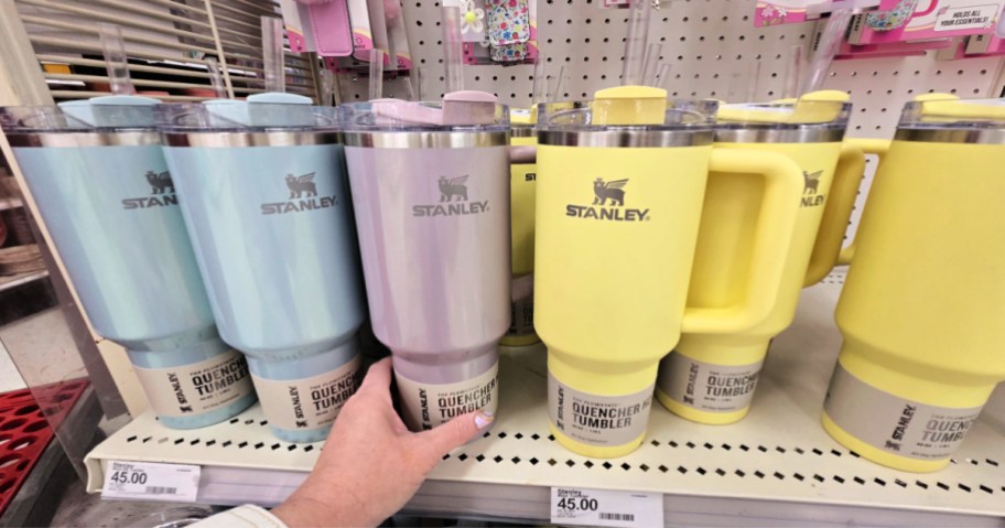 woman reaching for stanley tumblers