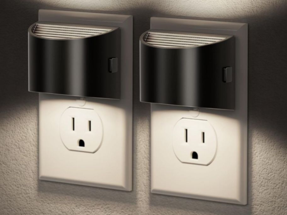 two silver night lights in outlet on wall