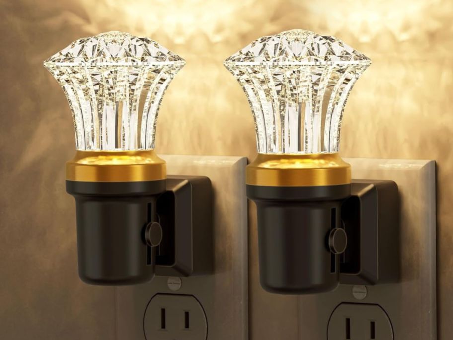 two diamond shaped crystal night lights in outlet on wall