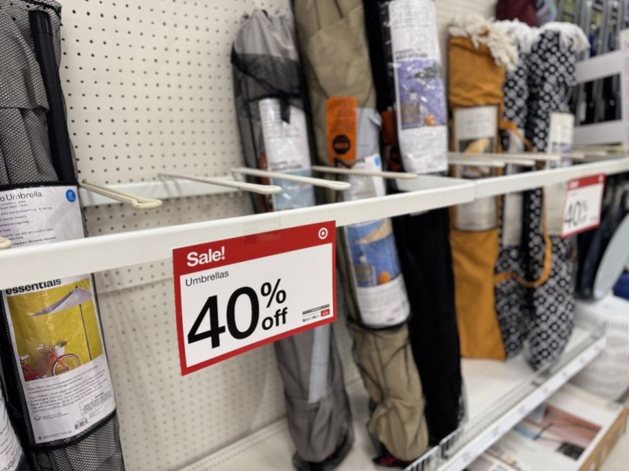 a selection of outdoor umbrellas on a store aisle