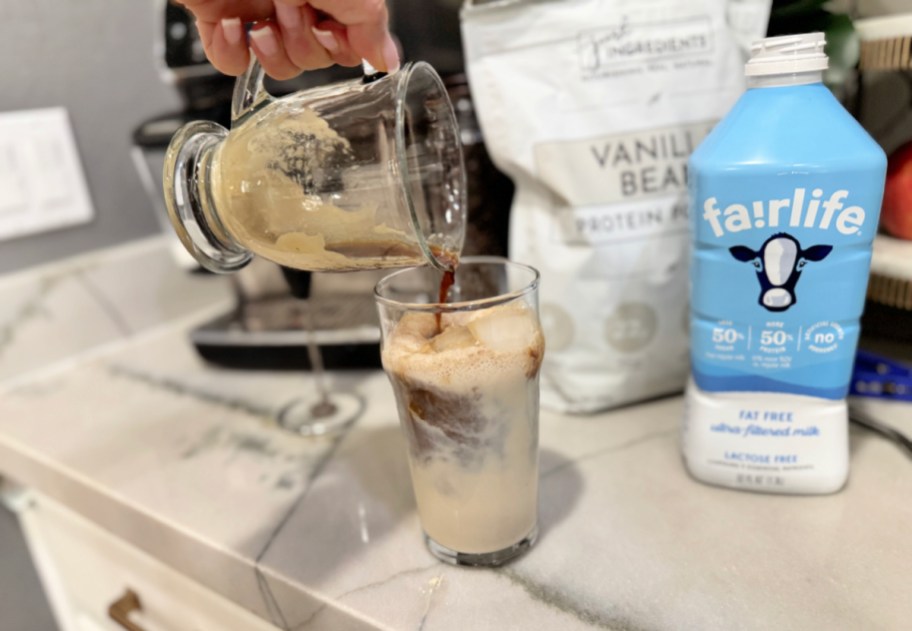 pouring brewed espresso into iced protein proffee 