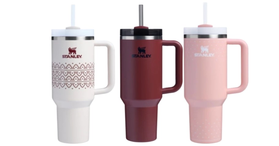 various colored stanley tumblers on white background
