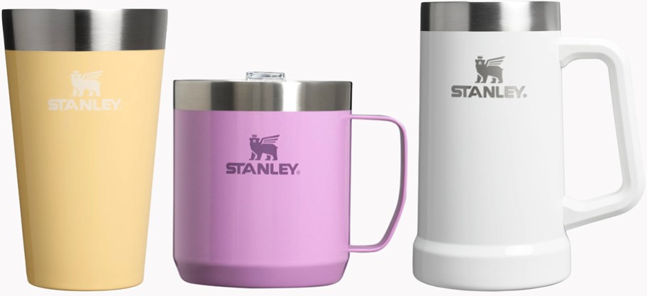 stanley yellow beer pint, pink mug, and white beer stine 