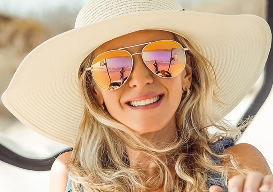 woman wearing aviator sunglasses and a wide brimmed hat