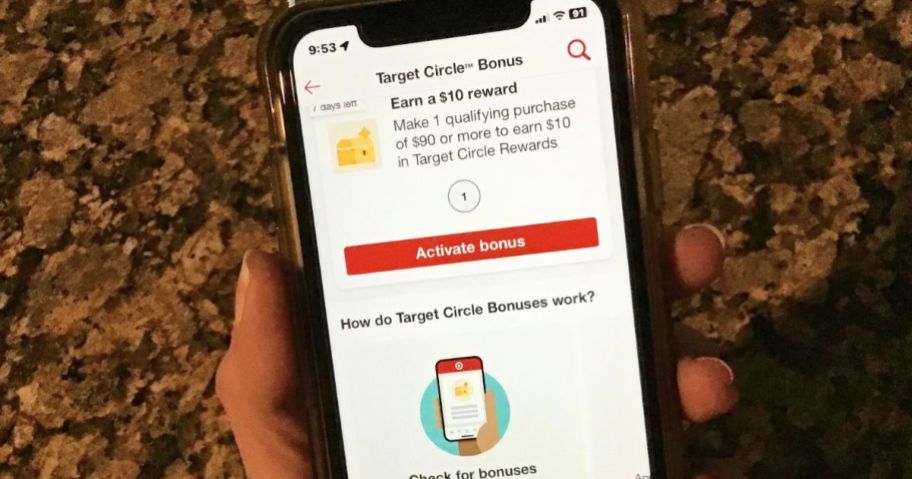 a womans hand holding a smart phone displaying a target circle bonus